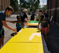 volunteers prepare to paint at Foster Park school during the 2017 Chicago Cares Serve-a-thon