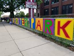 brightly-painted letters spell out the name "Foster Park" on the fence outside the school during the 2017 Chicago Cares Serve-a-thon