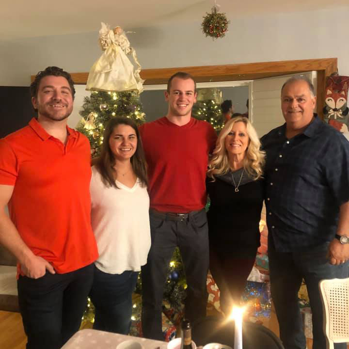 a family photo of Blake with his parents and siblings at home during Christmas