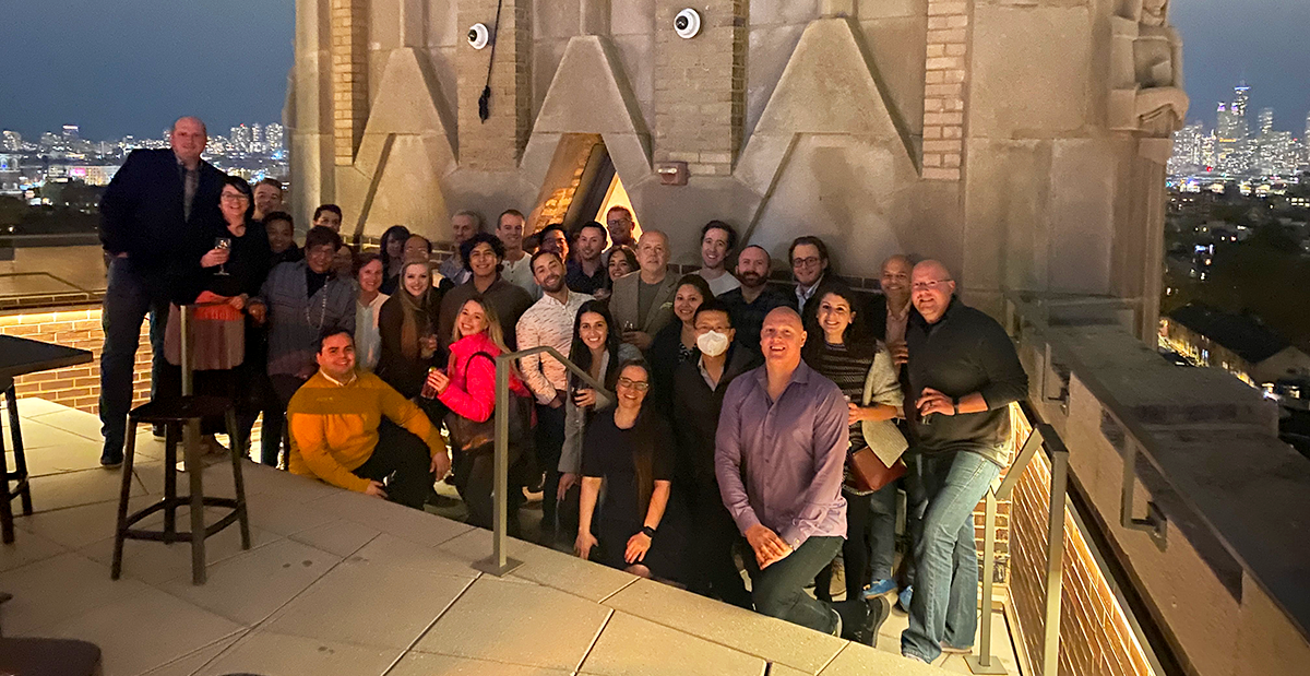 The Credico USA poses for a group photo on the rooftop of the Robey with a partial view of the Chicago skyline in the background