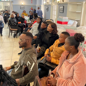 Credico South Africa parents watch as "Santa" distributes gifts at the 2022 Christmas in July
