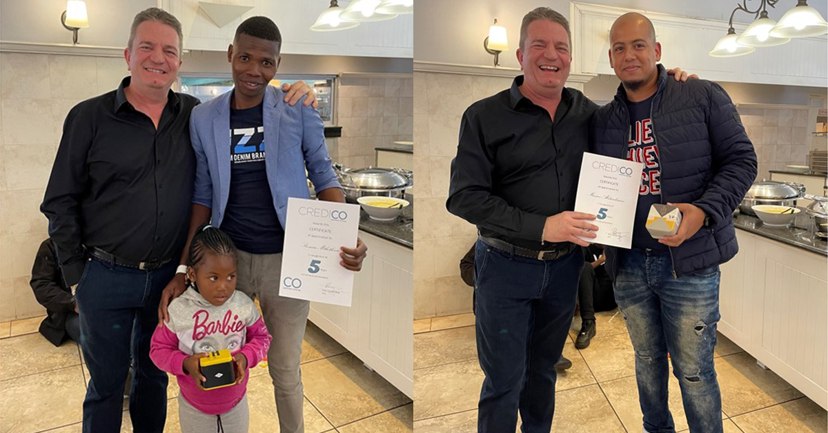 Promise Mthethwa and Munier Abdurahman pose proudly with Credico South Africa's CEO Peter Van Den Berg and their five-year recognition awards.