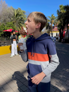 The son of a Credico SA staff member enjoys an ice cream cone at the Gold Reef City Theme Park during the 2022 Christmas in July outing