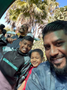 A Credico staff member poses with his family at the Gold Reef City Theme Park during Credico South Africa's Christmas in July outing