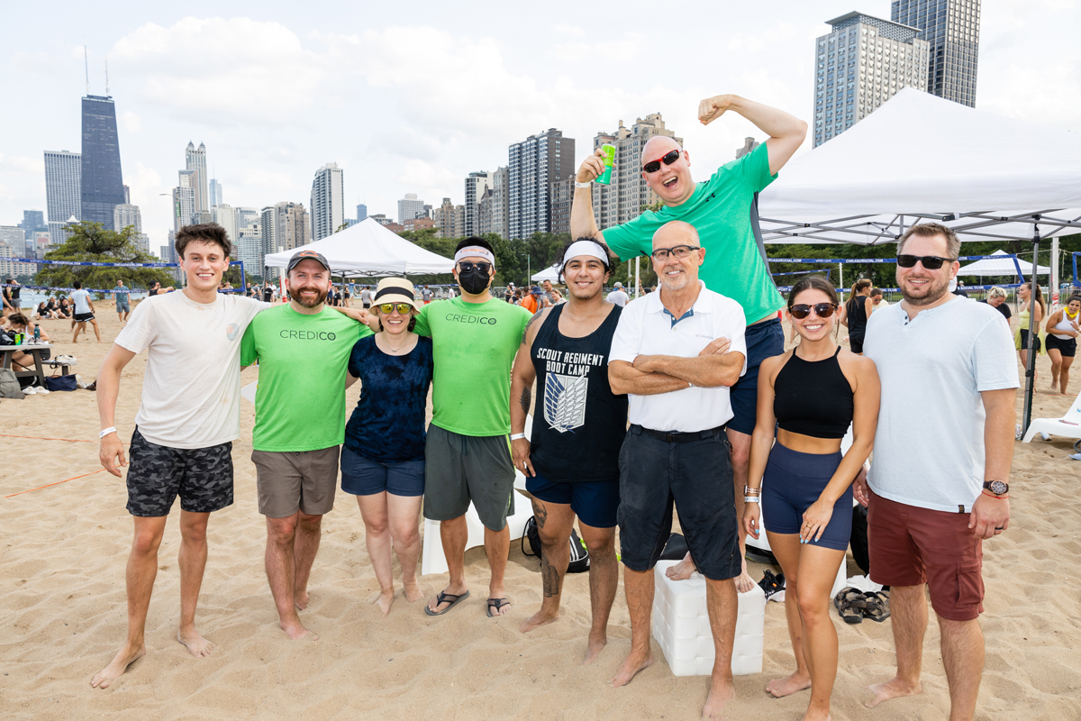 The Credico USA team poses for a group photo before the Chicago skyline at the 2022 Spike Against Cancer fundraiser