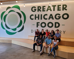 The Credico USA team of volunteers poses in front of the Greater Chicago Food Depository sign