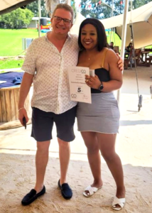 Credico South Africa recognizes Zamo Ntshulane for her 5 years of service. Here, Zamo stands with Peter van den Berg, CEO of Credico South Africa, while holding her award.