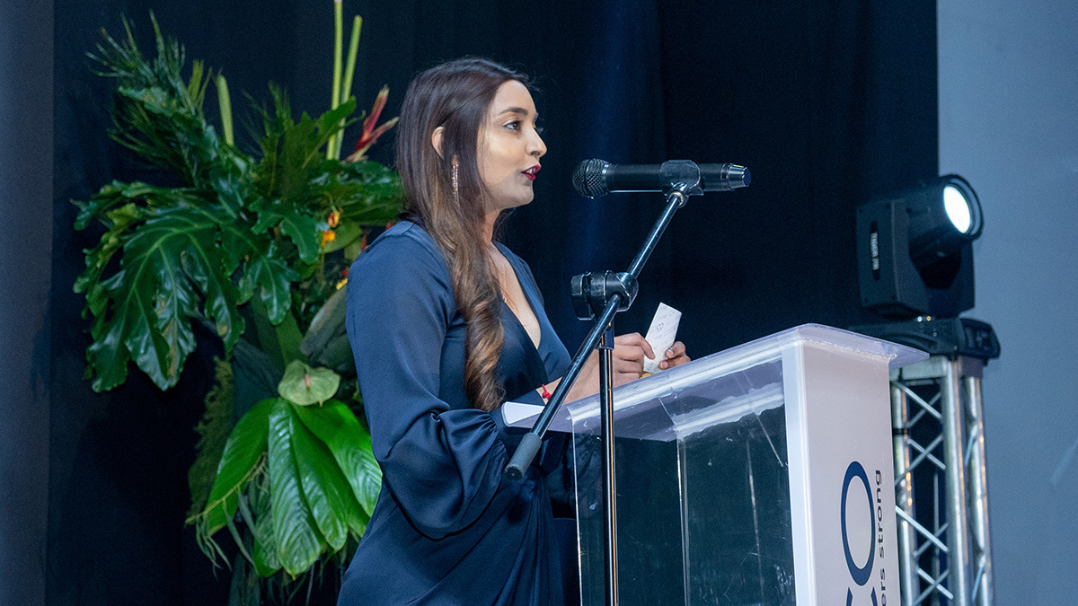 Davita Akaloo presents an award from behind a podium on stage at Credico South Africa's 2023 Awards Gala at Sun City Resort