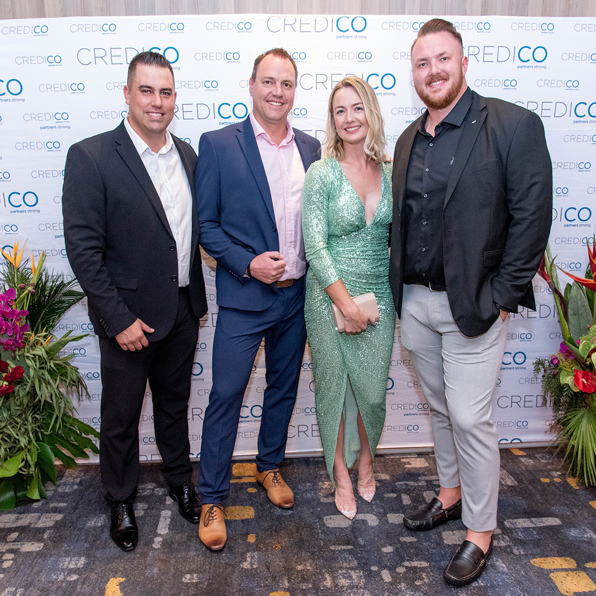Four smiling attendees pose in front of a Credico-branded backdrop before Credico South Africa's 2023 Awards Gala at Sun City Resort.