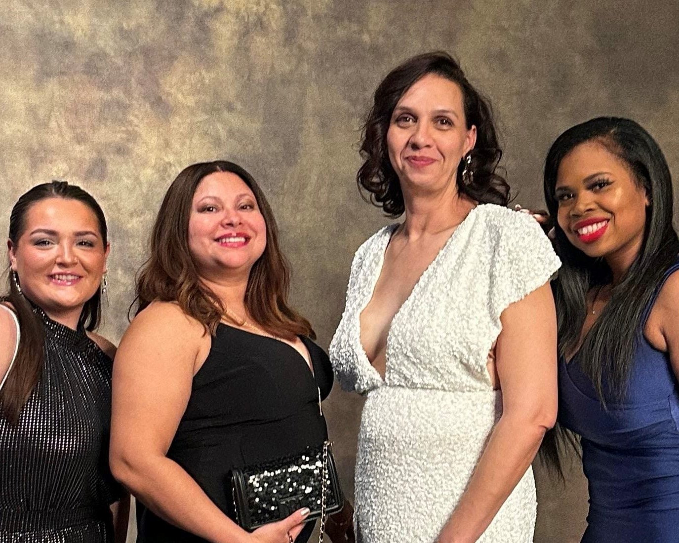 Four members of the Credico team pose in formal attire for a group photo at the 2024 Black Creativity Gala at Chicago's Museum of Science and Industry