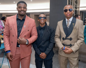 three attendees in suits pose for a photo during the South Africa Awards Gala in March 2025