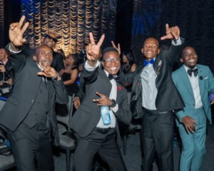 A group of excited attendees grin and cheer for the awardees during the South Africa Awards Gala in March 2025