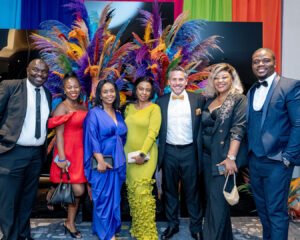 A group of smiling attendees poses for a photo in their finery at the South Africa Awards Gala in March 2025
