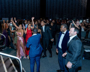 A crowd of attendees cheers from their places standing near the stage during the South Africa Awards Gala in March 2025